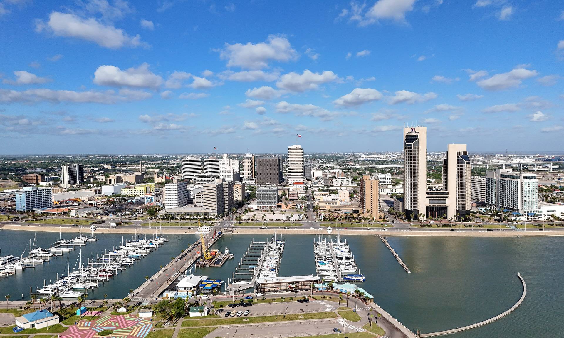 Corpus Christi bayfront and marina beneath a wide coastal sky